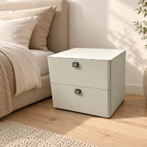 KAESID white two-drawer bedside table beside a bed in a warm modern bedroom